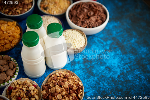 Image of Assortment of different kinds cereals placed in ceramic bowls on table