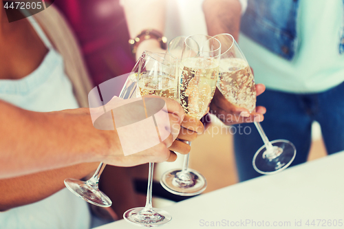 Image of friends clinking glasses of champagne at party