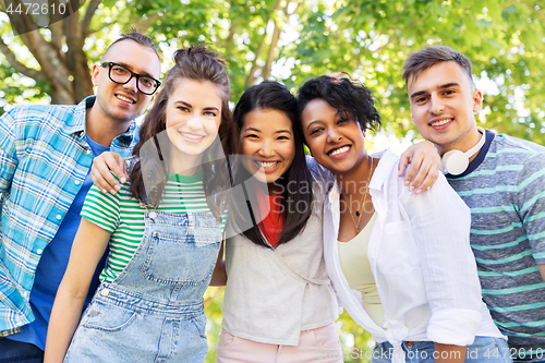 Image of happy international friends hugging in park