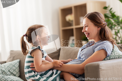 Image of pregnant mother and daughter at home