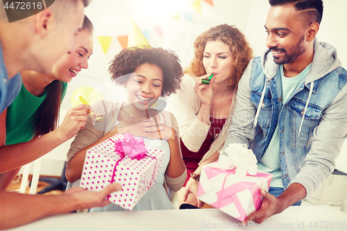 Image of team greeting colleague at office birthday party