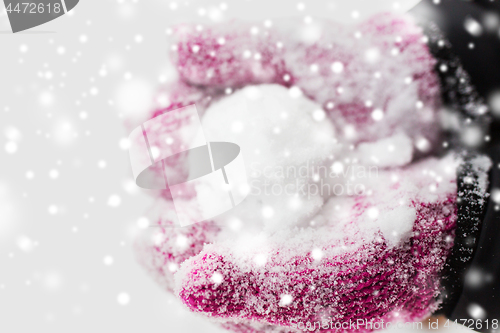 Image of close up of woman holding snowball outdoors