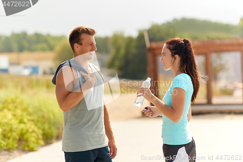 Image of couple with bottle of water after doing sports