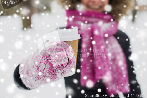 Image of close up of hand with coffee outdoors in winter