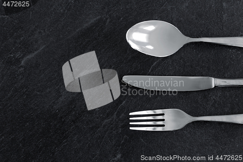 Image of close up of fork, knife and spoon on table