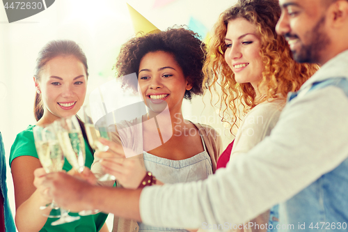 Image of friends clinking glasses of champagne at party