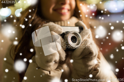 Image of close up of happy woman with camera at christmas