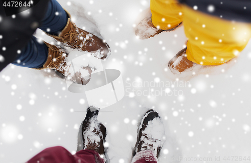 Image of group of people feet on snow