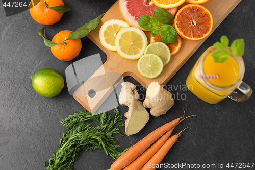 Image of fruits, vegetables, cutting board and juice