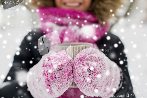 Image of close up of woman with tea mug outdoors in winter