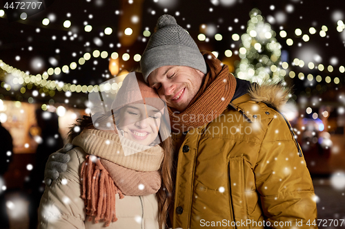 Image of happy couple hugging at christmas tree