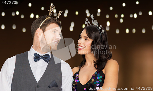 Image of couple with christmas or new year party props