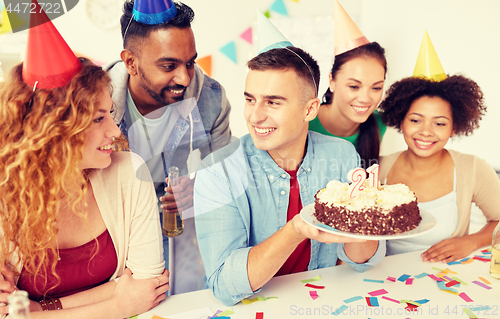 Image of team greeting colleague at office birthday party