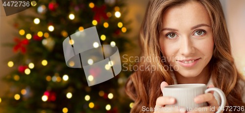 Image of close up of woman with coffee cup on christmas