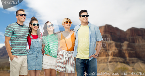 Image of friends in sunglasses over grand canyon