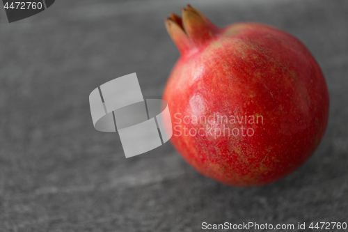 Image of close up of pomegranate on stone table