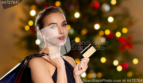 Image of woman with credit card shopping on christmas