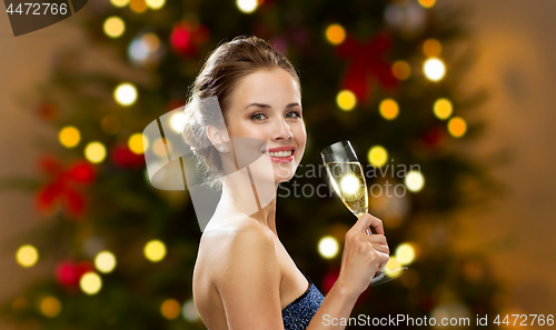 Image of woman with glass of champagne on christmas