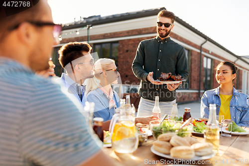 Image of friends at barbecue party on rooftop in summer