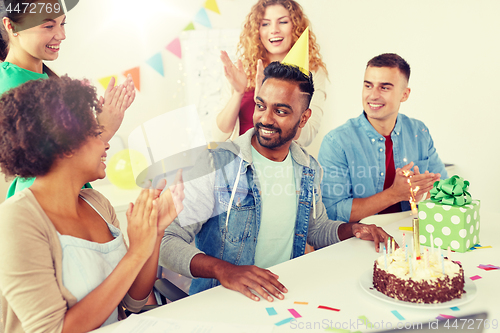 Image of office team greeting colleague at birthday party