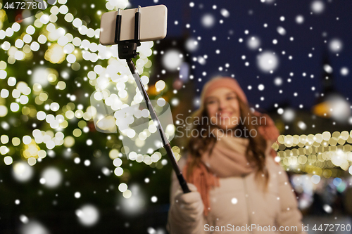 Image of young woman taking selfie at christmas town