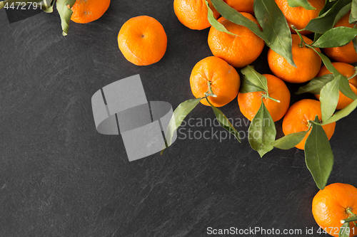 Image of close up of mandarins on slate table top