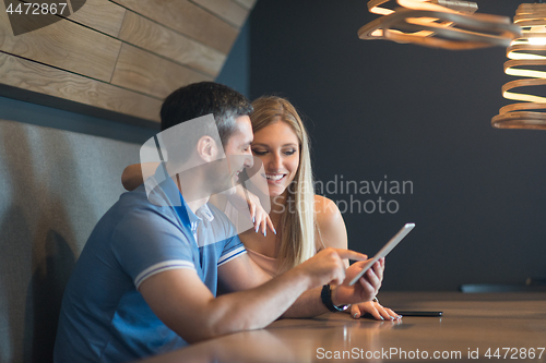 Image of couple using tablet at home