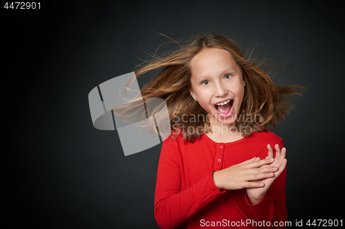 Image of Excited surprised preteen girl screaming of joy