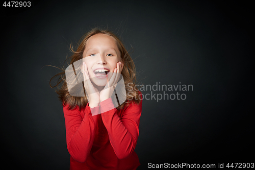 Image of Excited surprised preteen girl screaming of joy