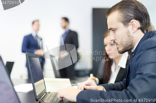 Image of Business people in modern corporate office.