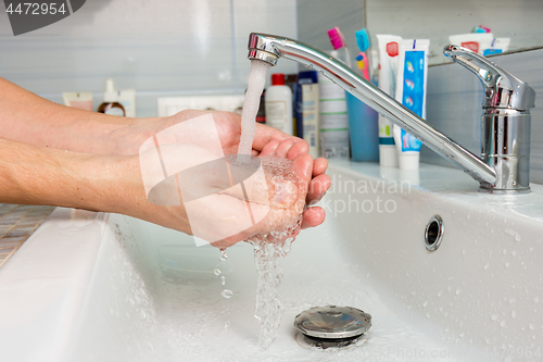 Image of Hands under the tap from the mixer