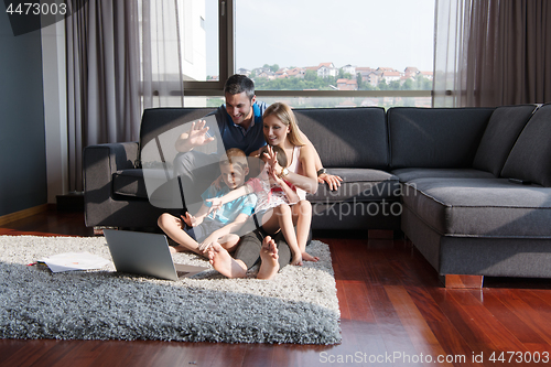 Image of Family Playing Together with laptop computer