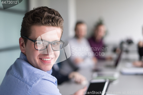 Image of Businessman using tablet in modern office