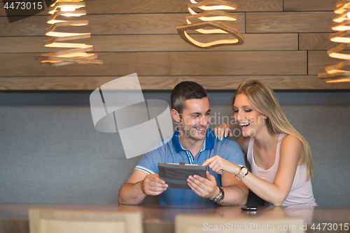 Image of couple using tablet at home