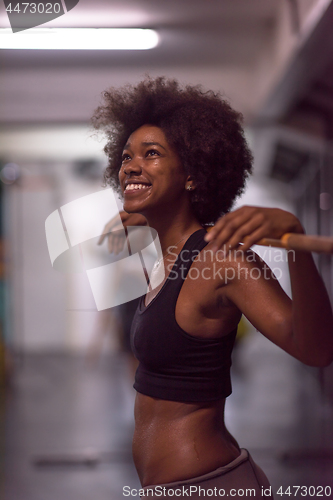 Image of black woman lifting empty bar