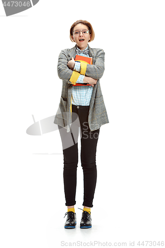 Image of Full length portrait of a surprised female student holding books isolated on white background