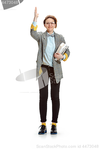 Image of Full length portrait of a happy smiling female student holding books isolated on white background