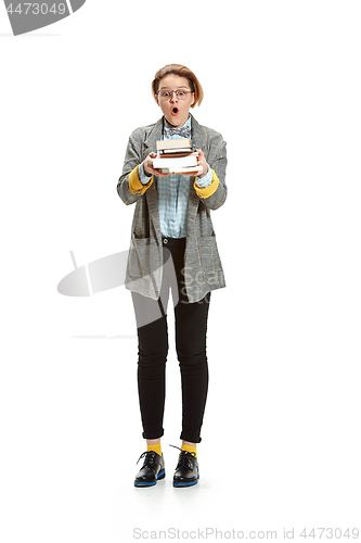 Image of Full length portrait of a surprised female student holding books isolated on white background