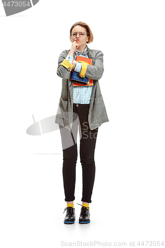 Image of Full length portrait of a unhappy female student holding books isolated on white background