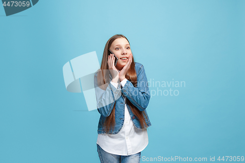 Image of Beautiful teen girl looking suprised isolated on blue