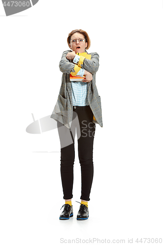 Image of Full length portrait of a surprised female student holding books isolated on white background