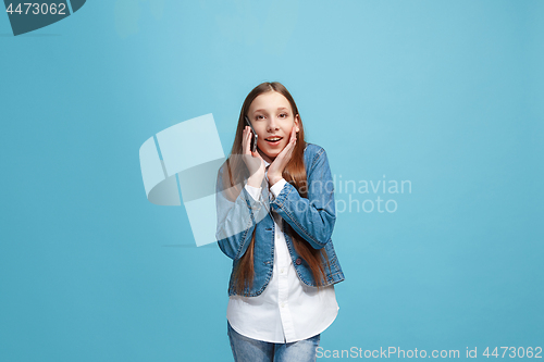 Image of Beautiful teen girl looking suprised isolated on blue