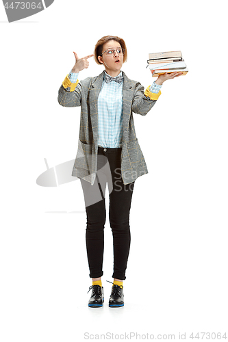 Image of Full length portrait of a happy smiling female student holding books isolated on white background