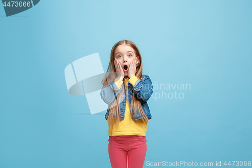 Image of Beautiful teen girl looking suprised isolated on blue