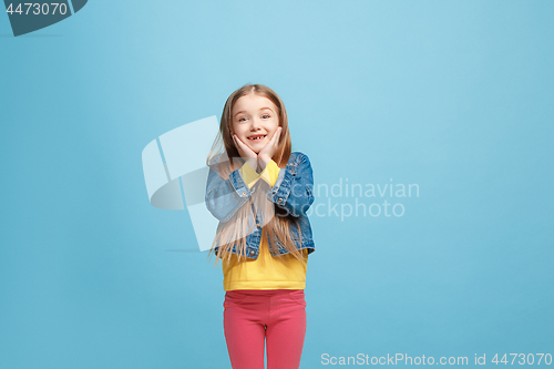 Image of Beautiful teen girl looking suprised isolated on blue