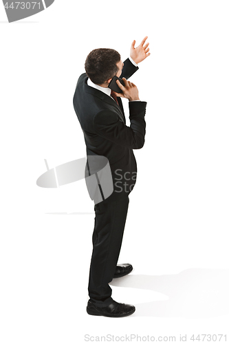 Image of Back view portrait of a businessman. Confident professional with mobile phone