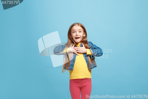 Image of Beautiful teen girl looking suprised isolated on blue