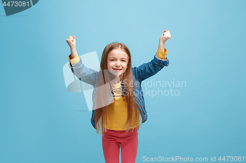 Image of Happy success teen girl celebrating being a winner. Dynamic energetic image of female model