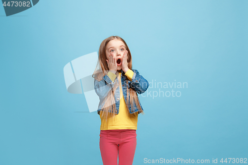Image of Beautiful teen girl looking suprised isolated on blue