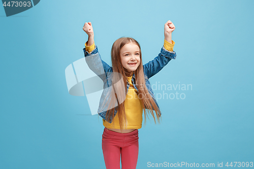 Image of Happy success teen girl celebrating being a winner. Dynamic energetic image of female model